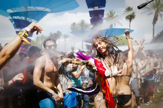 Crowds of people are drenched with water at the Do Lab on the first day of the Coachella Music and Arts Festival in Indio, Calif.