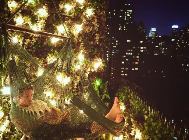 How to Turn Your Balcony Into a Private Sanctuary My hubby, Mike, reading in our one-person hammock