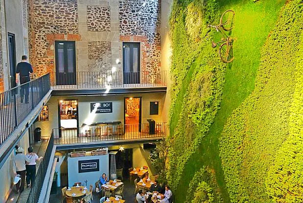 One of the two courtyard restaurants, open to the sky, and the second floor shops, bars and cafes. The third floor is hotel suites.