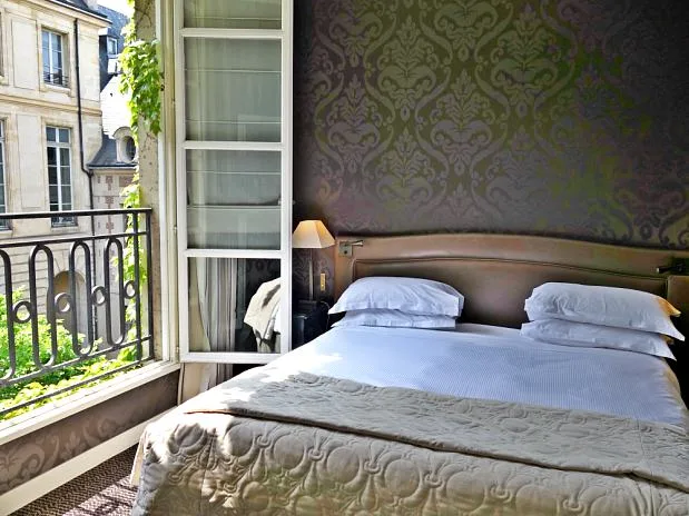 A Guide to Le Marais, Paris The window in the bedroom of our suite looked over the gorgeous courtyard